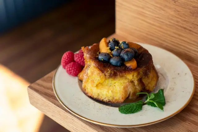 Breakfast bread pudding with homemade caramel, fresh fruit and mint